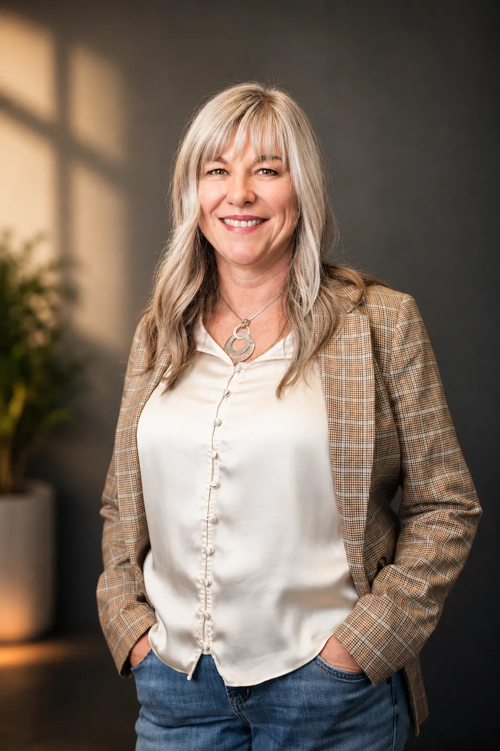 Cappi Bowers in a tweed blazer, smiling